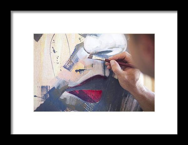 Working Framed Print featuring the photograph Close up of mature male artist working on canvas by Zero Creatives