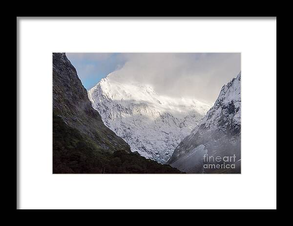 Milford Sound Framed Print featuring the photograph Clouds and Snow around Milford Sound One by Bob Phillips