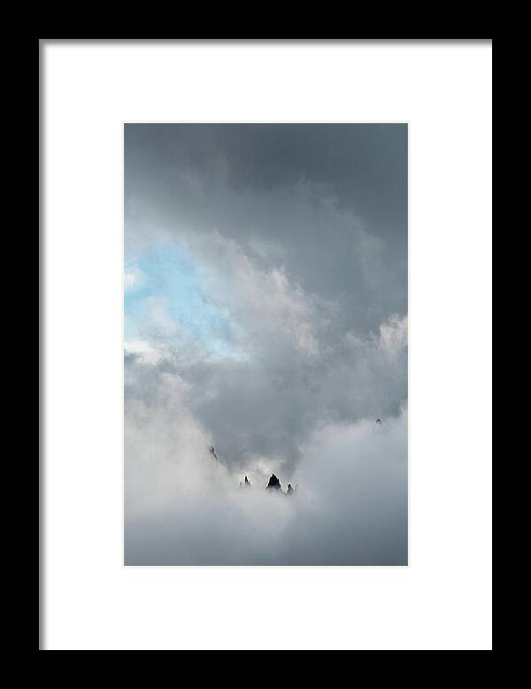Italian Alps Framed Print featuring the photograph Cloudy landscape with edge of rocky mountains between the stormy sky by Michalakis Ppalis