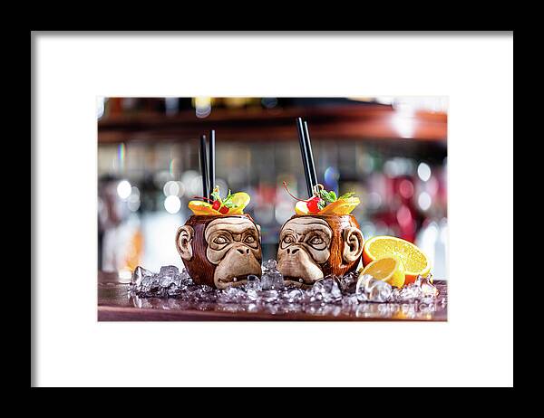 Cocktail Framed Print featuring the photograph Coctail in monkey mugs on bar counter by Michal Bednarek