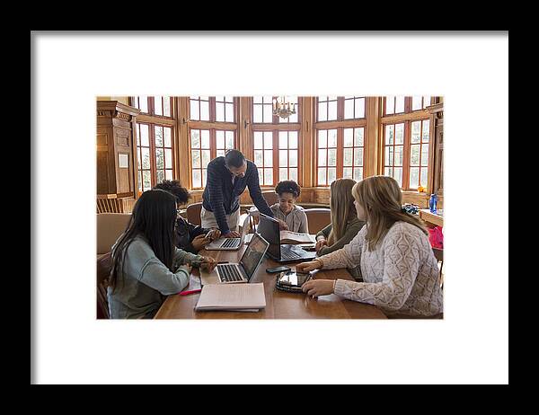Working Framed Print featuring the photograph College students using laptops by Yellowdog