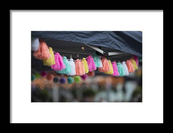 Event Framed Print featuring the photograph Colourful tassles hang from a tent during a market by Robyn Wood