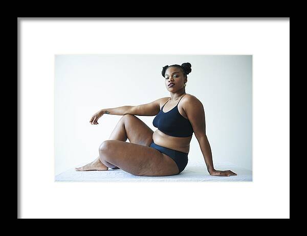 Curve Framed Print featuring the photograph Confident Curvy Woman Sitting And Looking To Camera by Tara Moore