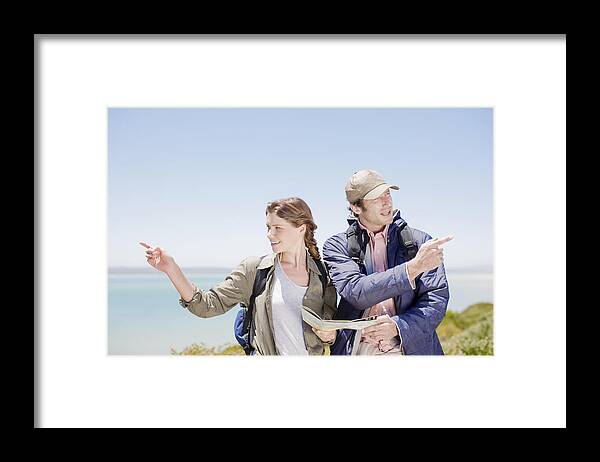 Confusion Framed Print featuring the photograph Couple hiking in remote area and looking at map by Paul Bradbury