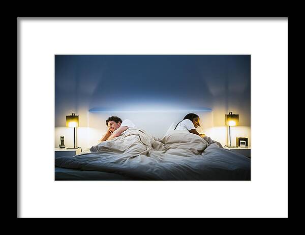 Problems Framed Print featuring the photograph Couple ignoring each other on bed by Portra