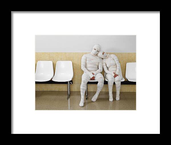 Heterosexual Couple Framed Print featuring the photograph Couple wrapped in bandages leaning together by Michael Blann
