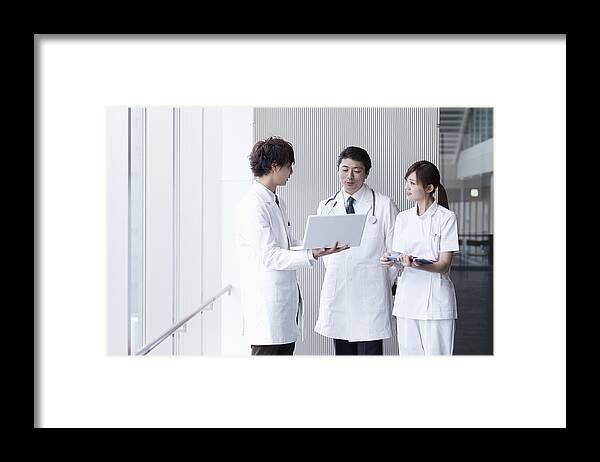 Young Men Framed Print featuring the photograph Doctors and nurse talking by Ultra.f