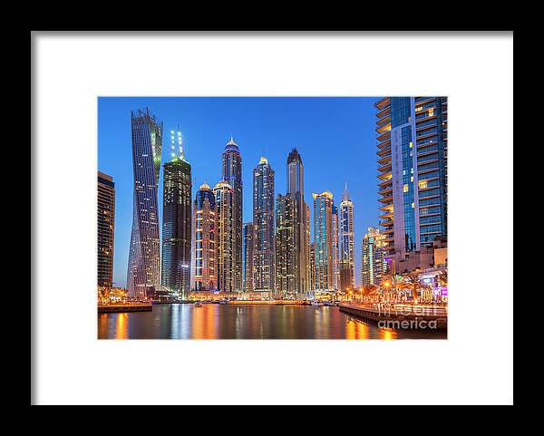 Dubai Skyline Night Framed Print featuring the photograph Dubai Marina Skyline at night by Neale And Judith Clark