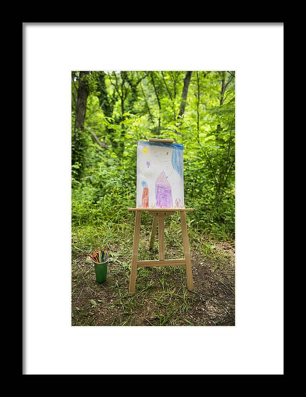 Outdoors Framed Print featuring the photograph Easel with child's drawing in forest by Evdokiageorgieva