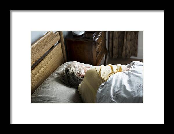 People Framed Print featuring the photograph Elderly caucasian woman sleeping on the bed by Rawpixel
