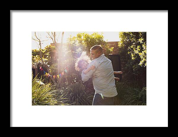 Diversity Framed Print featuring the photograph Father and little daughter's happy jumping moments in garden by Attila Csaszar