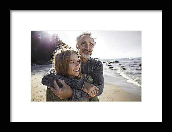 Sweater Framed Print featuring the photograph Father hugging daughter on the beach by Oliver Rossi