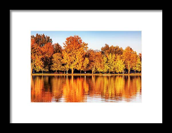 Fiery Colors Framed Print featuring the photograph Fiery autumn colors by the lake by Tatiana Travelways