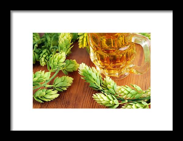 Alcohol Framed Print featuring the photograph fresh beer glass and hop typical for Beer Fest by Hsvrs