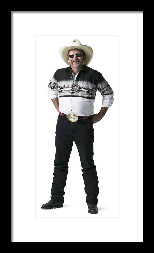 White Background Framed Print featuring the photograph Full Length Shot Of An Adult Male In A Cowboy Shirt And Hat As He Looks At The Camera by Photodisc