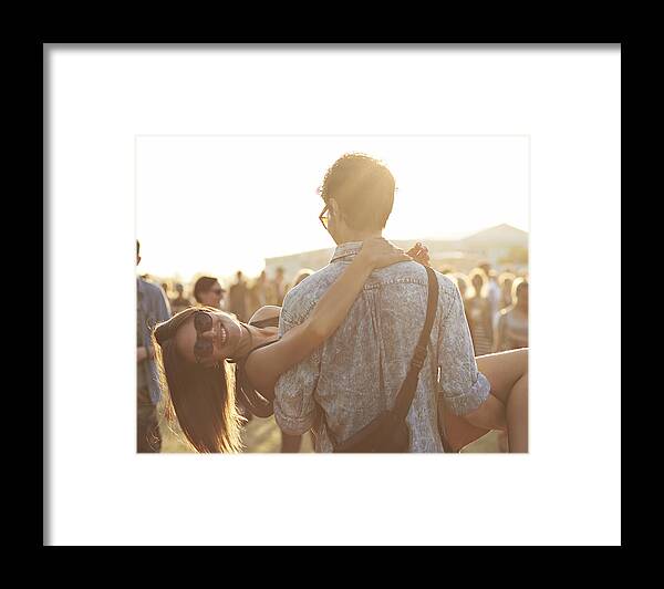 Young Men Framed Print featuring the photograph Girl getting carried by boyfrend at festival by Klaus Vedfelt