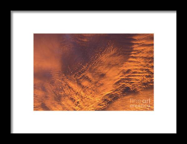 Clouds Framed Print featuring the photograph Glowing sunset sky with deep orange clouds by Adriana Mueller