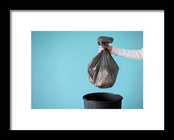 Problems Framed Print featuring the photograph Hand holding garbage in plastic bag by Grinvalds