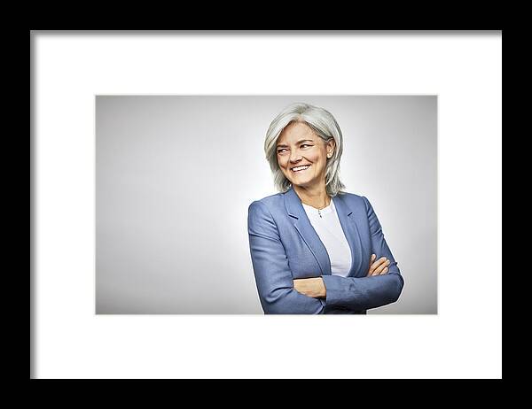 New Business Framed Print featuring the photograph Happy businesswoman with arms crossed looking away by Morsa Images
