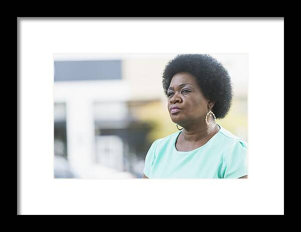 Natural Black Hair Framed Print featuring the photograph Head and shoulders of serious mature black woman by Kali9
