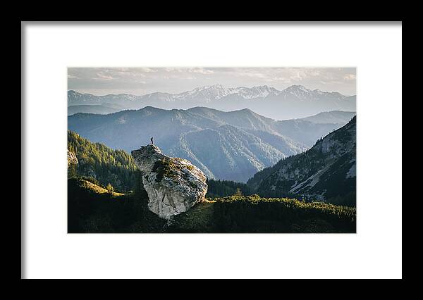 Tranquility Framed Print featuring the photograph Hiker relaxes on mountain ridge at sunrise by AscentXmedia