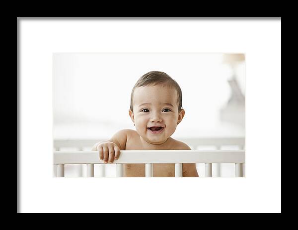 People Framed Print featuring the photograph Hispanic baby standing in crib by Jose Luis Pelaez Inc