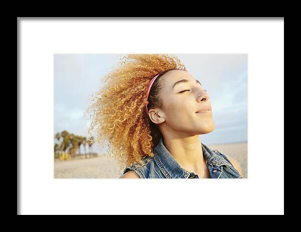 Tranquility Framed Print featuring the photograph Hispanic woman smiling at beach by Peathegee Inc