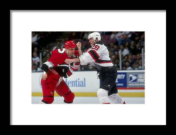 National Hockey League Framed Print featuring the photograph Hurricanes V Devils by Ezra Shaw