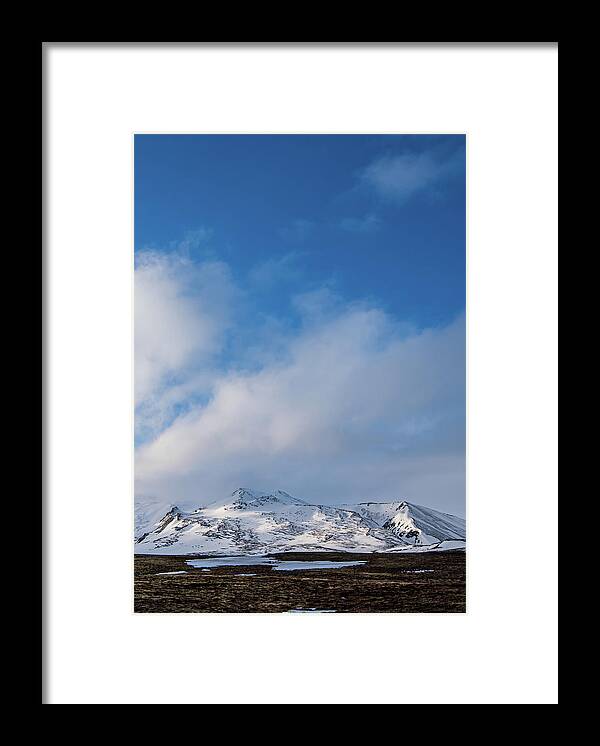 Iceland Framed Print featuring the photograph Icelandic landscape with mountains and meadow land covered in sn by Michalakis Ppalis