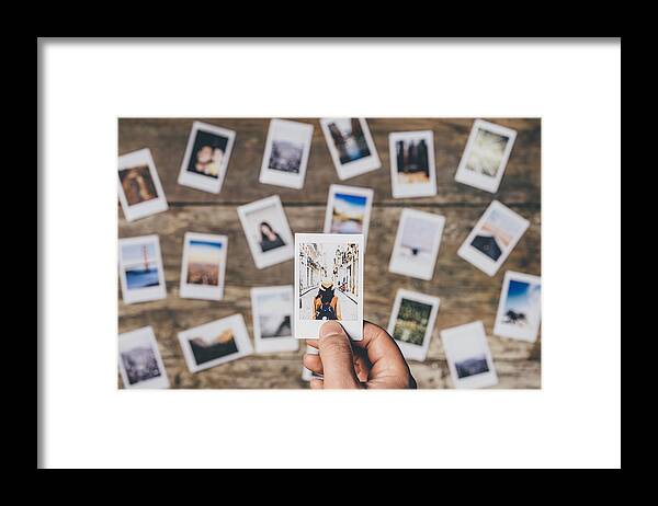 Choosing Framed Print featuring the photograph Instant camera prints on a table by FilippoBacci
