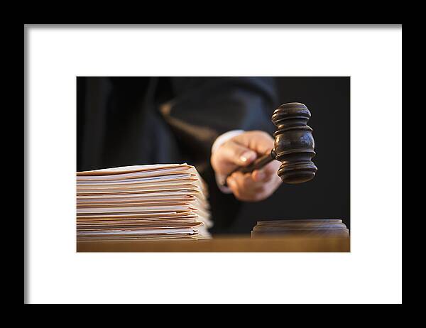 Mature Adult Framed Print featuring the photograph Judge holding gavel, close-up by Tetra Images