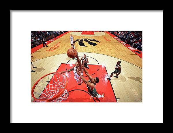 Kawhi Leonard Framed Print featuring the photograph Kawhi Leonard and Giannis Antetokounmpo by Jesse D. Garrabrant