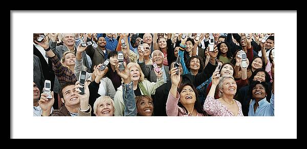 Human Arm Framed Print featuring the photograph Large Crowd of People Holding Their Mobile Phones in the Air by Digital Vision.