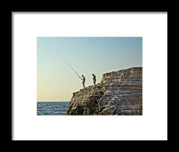 Life-style Beautiful Pleasant Warm Dusk Fishing Sea Blue Pinky Yellow Sky Quiet Calm Two Duo Couple Man Hobbies People Persons Figures Hill Watching Waiting Sunbathing Enjoying Enjoyable Serene Alone Delicate Gentle Delightful Mindfulness Friends Conceptual Relaxing Relaxation Cyprus Landscape Seascape Holiday Vacation Summer Dream Humor Angling Trawling Rod Candid Photography Fishermen Fisherman Characters Pastel Untroubled Peaceful Still Cliff Catch Rest Restful Singular Bright Vibrant Day Wow Framed Print featuring the photograph Life Is Beautiful - Fishing Dream Holiday by Tatiana Bogracheva