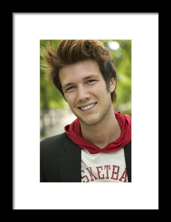 One Man Only Framed Print featuring the photograph Lifestyle Shot Of A Stylish Young Adult Male As He Smiles At The Camera by Photodisc