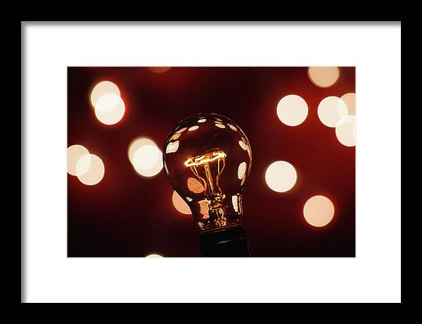 Light Bulb Framed Print featuring the photograph Light Bulb Bokeh by Gary Geddes