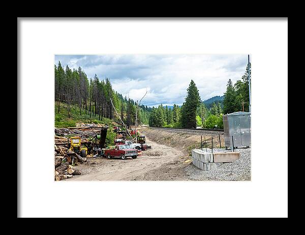 Log Pile Near Bnsf Tracks Framed Print featuring the photograph Log Pile Near BNSF Tracks by Tom Cochran