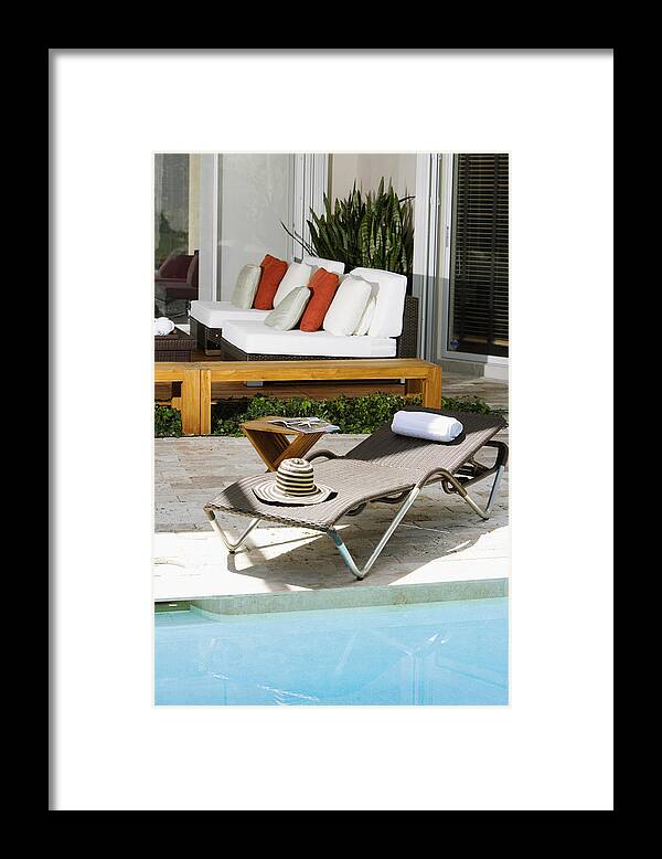 Shadow Framed Print featuring the photograph Lounge chair at the poolside by Glowimages