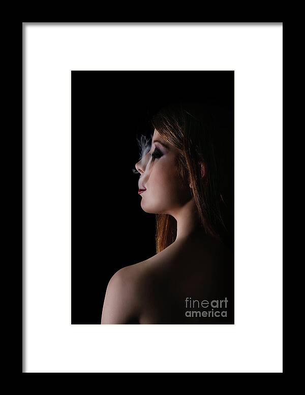 Beauty Framed Print featuring the photograph Low key portrait of a woman with smoke coming out of her mouth by Mendelex Photography