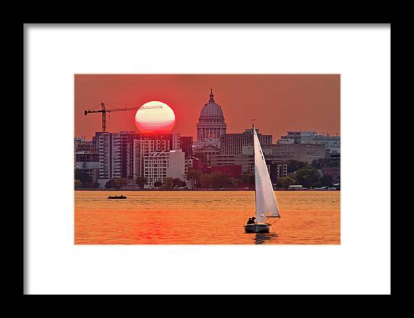 Madison Framed Print featuring the photograph Madison Equinox - Sun setting near madison WI capitol dome with lake monona and sailboat by Peter Herman
