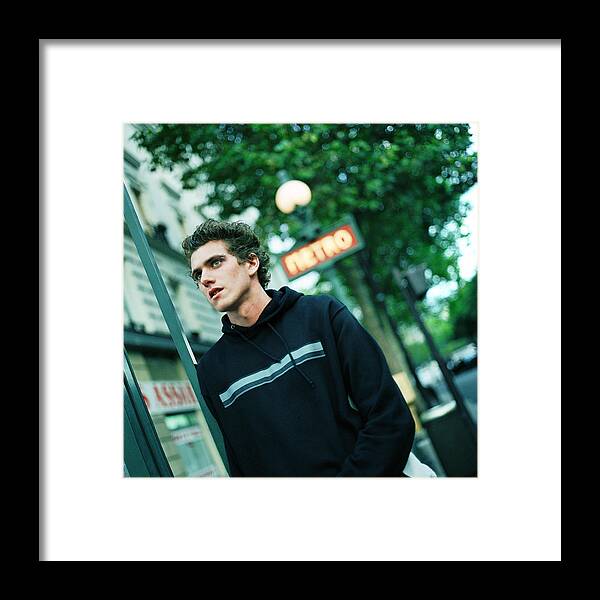 Grainy Framed Print featuring the photograph Male teenager under a blurred subway sign by Patrick Sheandell O'Carroll