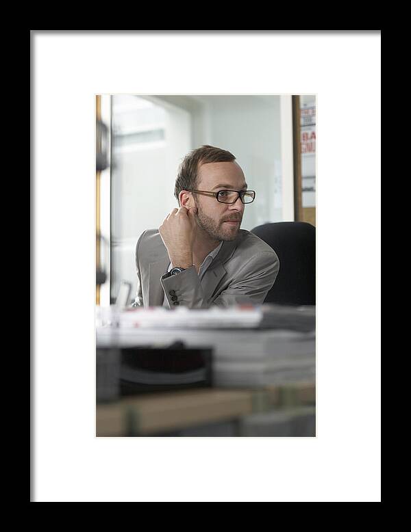 Working Framed Print featuring the photograph Man At Desk Listens by Michael Blann