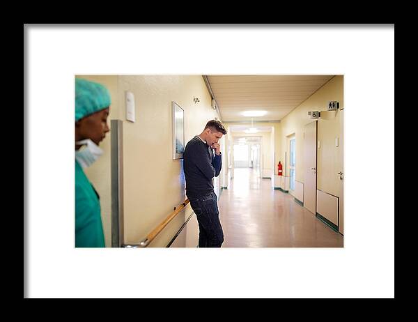 Medical Building Framed Print featuring the photograph Man filling nervous while waiting in hospital corridor by Luis Alvarez