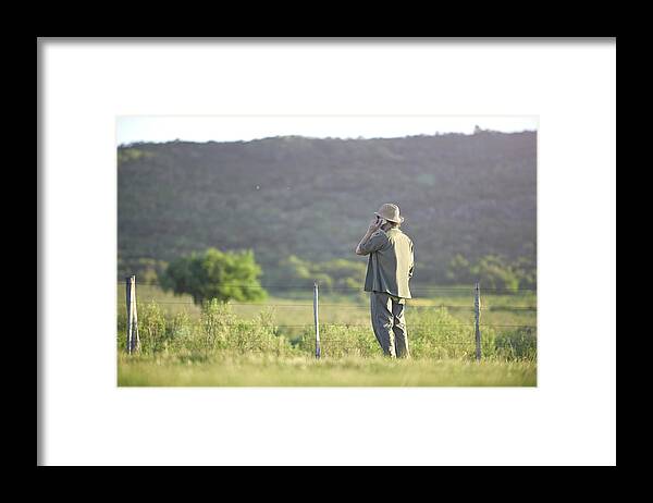 Scenics Framed Print featuring the photograph Man talking with smartphone in landscape by Domino