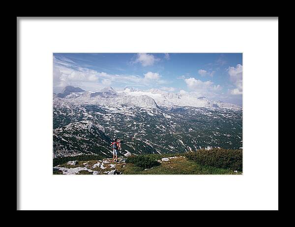Sportive Framed Print featuring the photograph Man with a backpack looks at the Dachstein massif by Vaclav Sonnek