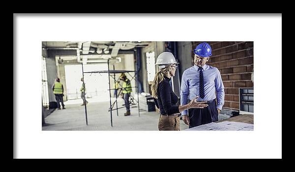 Looking Framed Print featuring the photograph Manager talking to architect at construction site by Vm