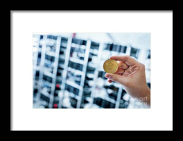 Bitcoin Framed Print featuring the photograph Man's hand showing bitcoin coin by Michal Bednarek