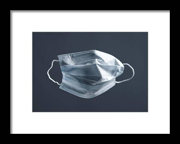 Cold And Flu Framed Print featuring the photograph Medical Used Face Mask, Protects Against Virus. Concept Of Air Pollution, Pneumonia Outbreaks, Coronavirus Epidemics, And The Risk Of Biological Contamination. by Aleksandr Zubkov