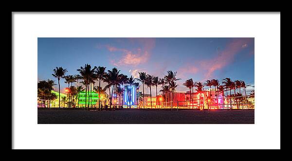 Miami Beach Framed Print featuring the photograph Miami Beach Ocean Drive panorama with hotels and restaurants at sunset. City skyline with palm trees at night. Art deco nightlife on South beach by Maria Kray