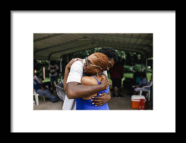 Young Men Framed Print featuring the photograph Middle aged black mother hugging her son by Willie B. Thomas